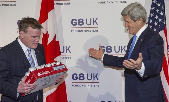 Canadian Minister of Foreign Affairs John Baird, left, gives up a case of Molson Canadian beer to US Secretary of State John Kerry , Thursday April 11, 2013 to pay off an earlier gentlemen's bet on the IIHF women's hockey championship which the U.S. won. THE CANADIAN PRESS/AP, Paul J. Richards, pool